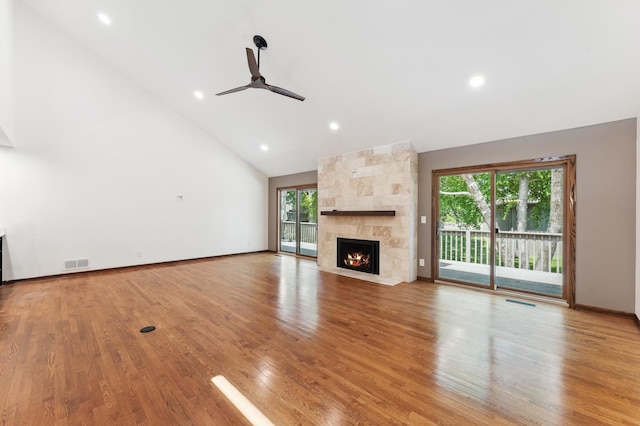 1775 Lexington Ave S Unit 26, Lilydale, MN 55118 - unfurnished living room with plenty of natural light, a large fireplace, light wood-style floors, high vaulted ceiling, and recessed lighting