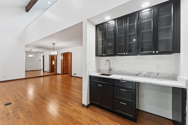 1775 Lexington Ave S Unit 26, Lilydale, MN 55118 - bar featuring a chandelier, wood finished floors, and decorative light fixtures