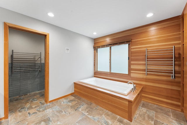 1775 Lexington Ave S Unit 26, Lilydale, MN 55118 - full bathroom featuring a towel warming rack, stone tile floors, a bath, recessed lighting, and radiator