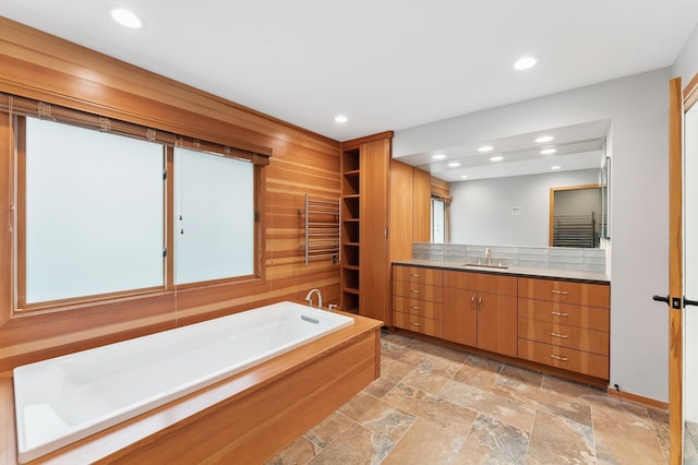 1775 Lexington Ave S Unit 26, Lilydale, MN 55118 - full bath featuring a garden tub, vanity, stone tile floors, recessed lighting, and a towel warming rack