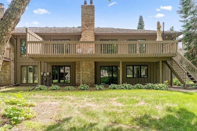 1775 Lexington Ave S Unit 26, Lilydale, MN 55118 - rear view of house with a chimney, board and batten siding, stairway, and a lawn