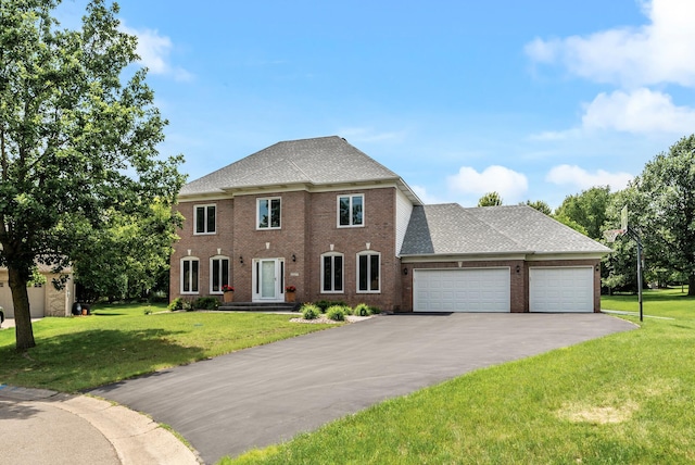 2227 Stone Creek Ln E, Chanhassen, MN 55317 - view of front facade with a garage, driveway, a front lawn, and brick siding