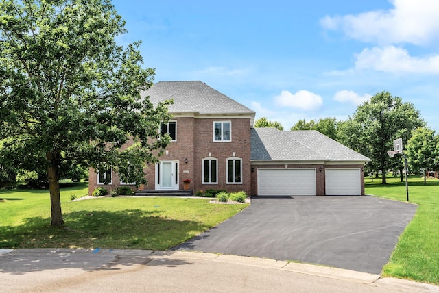 2227 Stone Creek Ln E, Chanhassen, MN 55317 - view of front facade featuring a garage, brick siding, driveway, and a front yard
