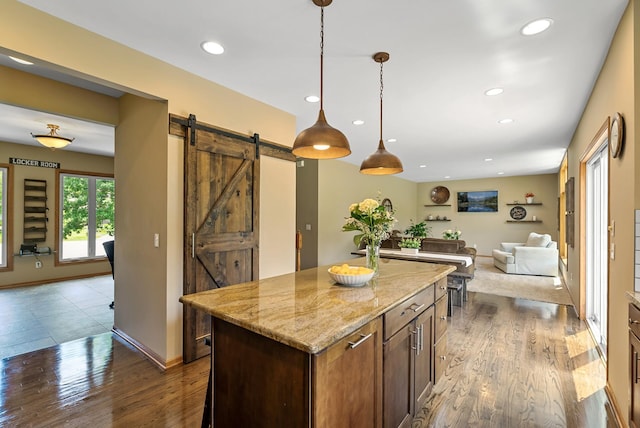 2227 Stone Creek Ln E, Chanhassen, MN 55317 - kitchen with a barn door, open floor plan, dark wood finished floors, a center island, and recessed lighting
