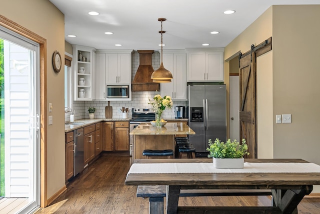2227 Stone Creek Ln E, Chanhassen, MN 55317 - kitchen with appliances with stainless steel finishes, custom exhaust hood, dark wood-type flooring, tasteful backsplash, and a barn door