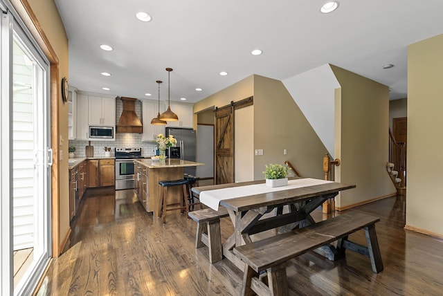 2227 Stone Creek Ln E, Chanhassen, MN 55317 - dining area featuring a barn door, dark wood-style floors, and recessed lighting