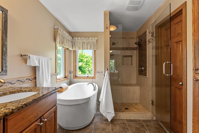 2227 Stone Creek Ln E, Chanhassen, MN 55317 - bathroom with a shower stall, a soaking tub, vanity, a textured ceiling, and a wainscoted wall