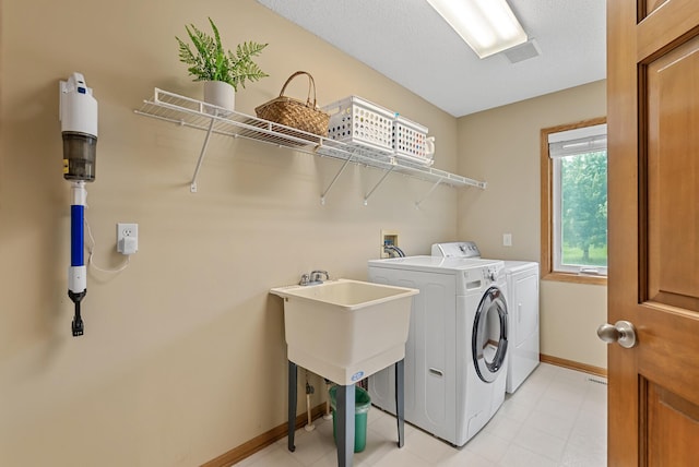 2227 Stone Creek Ln E, Chanhassen, MN 55317 - laundry area with washing machine and clothes dryer and baseboards
