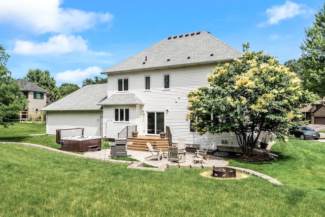 2227 Stone Creek Ln E, Chanhassen, MN 55317 - back of property featuring a patio area, a hot tub, a yard, a fire pit, and roof with shingles