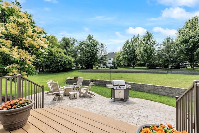 2227 Stone Creek Ln E, Chanhassen, MN 55317 - wooden deck featuring a fire pit, a grill, a lawn, and a patio area