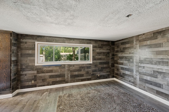 3950 Upper 75th St E, Inver Grove Heights, MN 55076 - empty room featuring wood walls, wood finished floors, and a textured ceiling