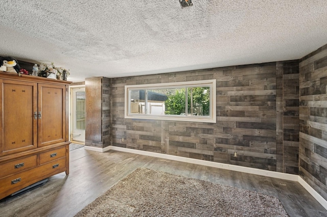 3950 Upper 75th St E, Inver Grove Heights, MN 55076 - unfurnished bedroom with wood finished floors, a textured ceiling, and wood walls