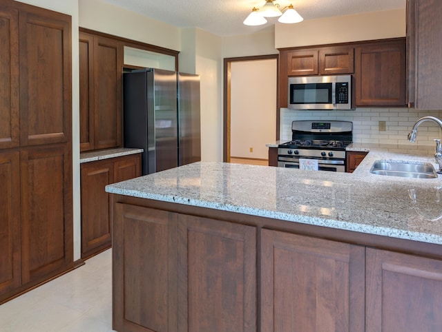 1132 Westbury Cir, Eagan, MN 55123 - kitchen featuring stainless steel appliances, tasteful backsplash, light stone counters, and a peninsula