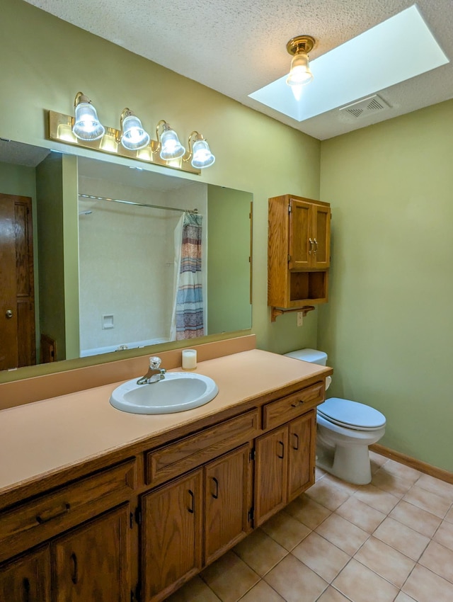 1132 Westbury Cir, Eagan, MN 55123 - bathroom with a skylight, vanity, tile patterned floors, a shower with shower curtain, and a textured ceiling