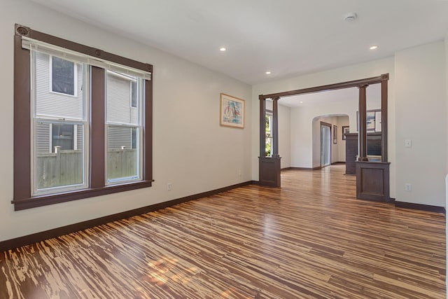 981 Bayless Ave, Saint Paul, MN 55114 - empty room featuring arched walkways, dark wood-style floors, a smoke detector, and recessed lighting