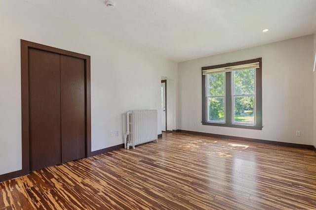 981 Bayless Ave, Saint Paul, MN 55114 - unfurnished bedroom featuring radiator, wood finished floors, and recessed lighting