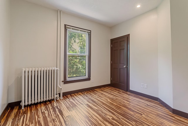 981 Bayless Ave, Saint Paul, MN 55114 - unfurnished room with radiator, wood finished floors, and recessed lighting