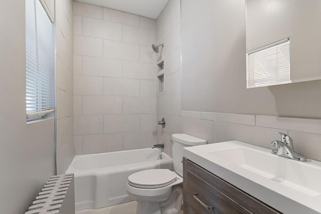 981 Bayless Ave, Saint Paul, MN 55114 - full bath featuring radiator, vanity, washtub / shower combination, tile walls, and a wainscoted wall