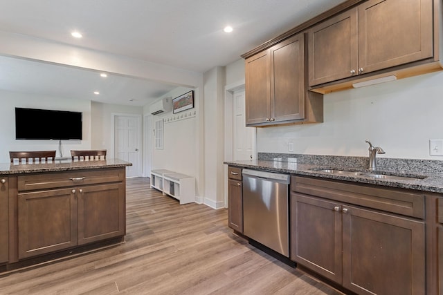 981 Bayless Ave, Saint Paul, MN 55114 - kitchen featuring stainless steel dishwasher, light wood-style flooring, a wall mounted air conditioner, dark stone countertops, and recessed lighting
