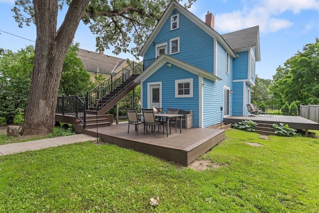 981 Bayless Ave, Saint Paul, MN 55114 - rear view of property with stairway, a shingled roof, a wooden deck, a chimney, and outdoor dining space