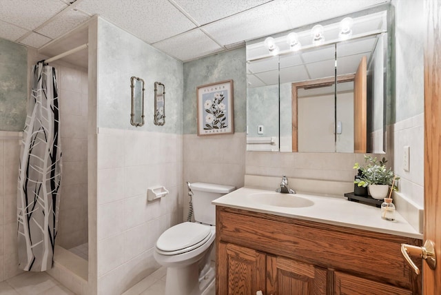7795 Van Buren St NE, Spring Lake Park, MN 55432 - bathroom with vanity, tile walls, tiled shower, tile patterned flooring, and wainscoting