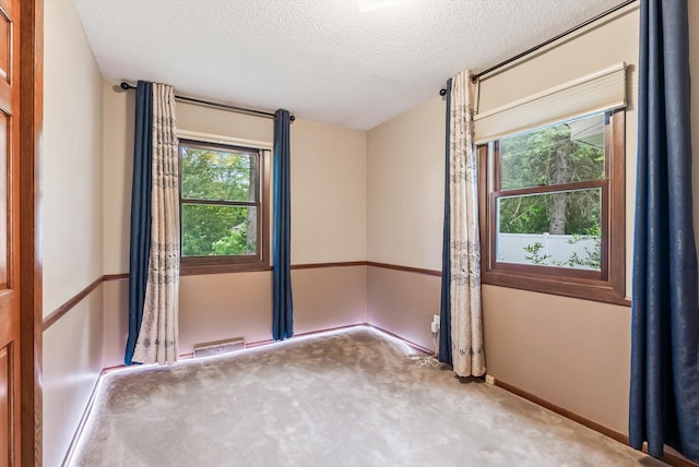7795 Van Buren St NE, Spring Lake Park, MN 55432 - carpeted spare room featuring a textured ceiling and baseboards