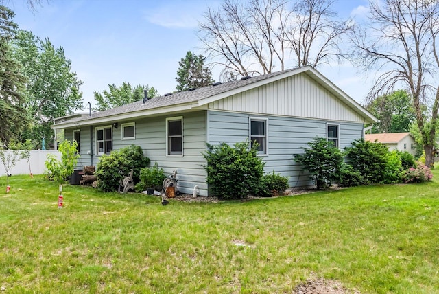 7795 Van Buren St NE, Spring Lake Park, MN 55432 - view of home's exterior with a central AC unit and roof with shingles