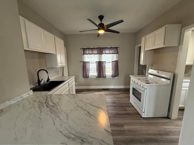 1678 Minnehaha Ave E, Saint Paul, MN 55106 - kitchen with white range with gas cooktop, a ceiling fan, dark wood-style floors, and white cabinetry