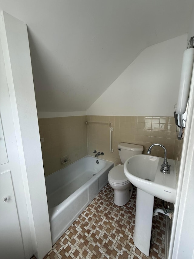 1678 Minnehaha Ave E, Saint Paul, MN 55106 - full bathroom with vaulted ceiling, a tub to relax in, and tile walls
