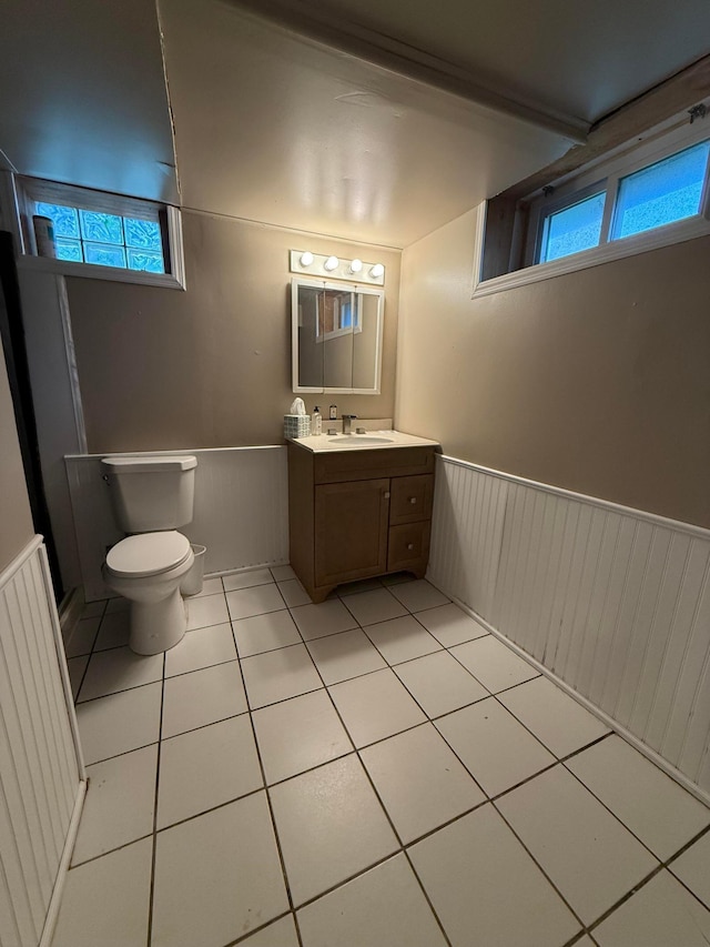 1678 Minnehaha Ave E, Saint Paul, MN 55106 - bathroom featuring a wainscoted wall, tile patterned flooring, and vanity