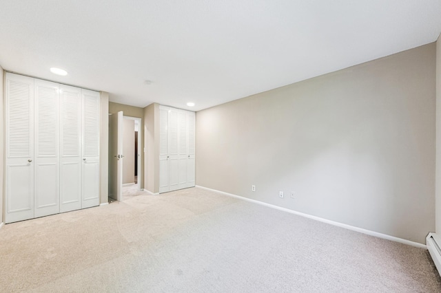 10311 Cedar Lake Rd Unit 210, Minnetonka, MN 55305 - unfurnished bedroom featuring carpet flooring, recessed lighting, a baseboard radiator, and two closets