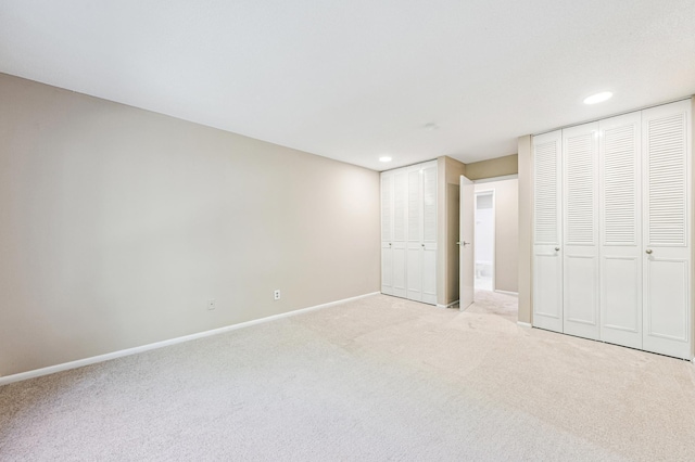 10311 Cedar Lake Rd Unit 210, Minnetonka, MN 55305 - unfurnished bedroom featuring multiple closets, light colored carpet, and recessed lighting