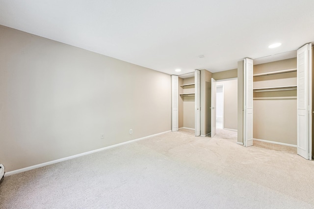 10311 Cedar Lake Rd Unit 210, Minnetonka, MN 55305 - unfurnished bedroom with multiple closets, light colored carpet, and recessed lighting