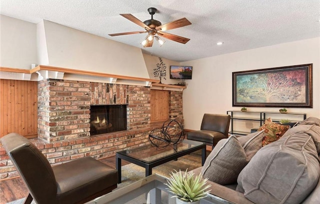 10311 Cedar Lake Rd Unit 210, Minnetonka, MN 55305 - living room featuring a ceiling fan, a textured ceiling, a brick fireplace, wood walls, and recessed lighting