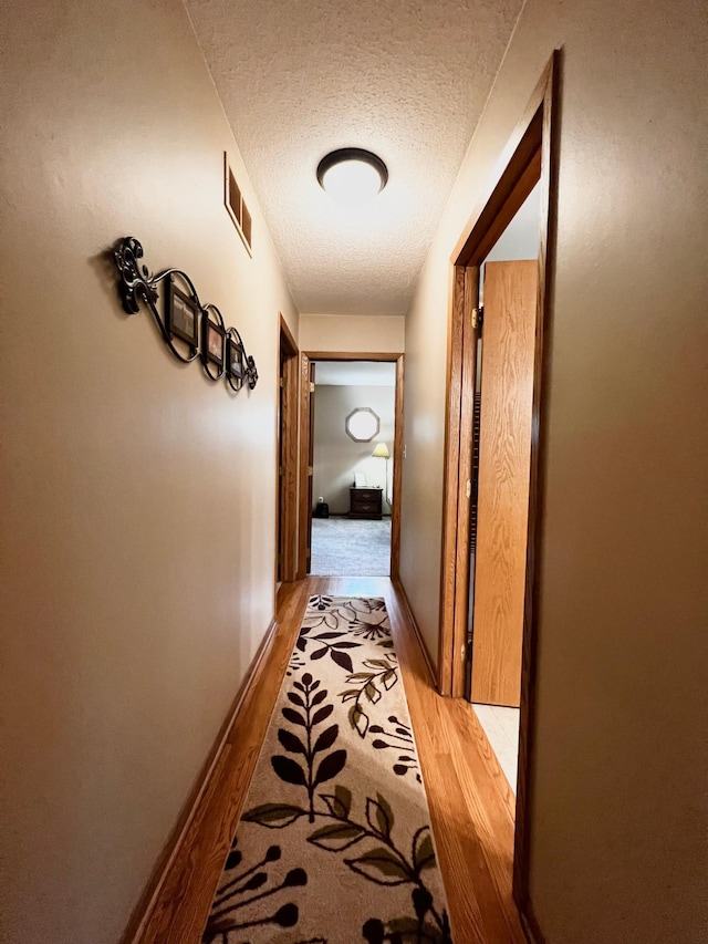4095 125th St SE, Granite Falls, MN 56241 - corridor with light wood-style floors and a textured ceiling