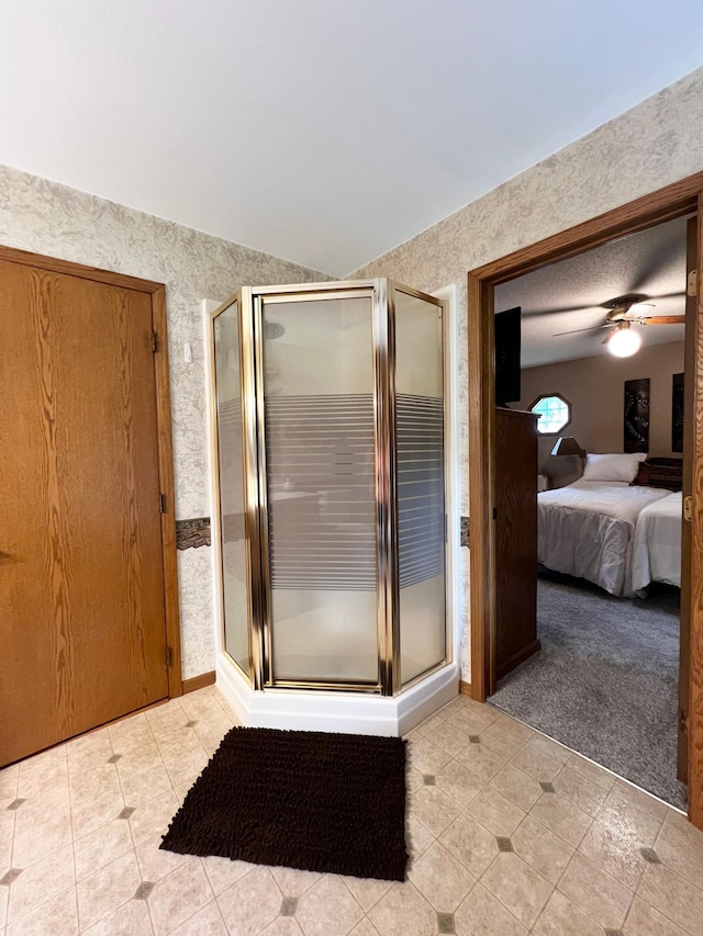 4095 125th St SE, Granite Falls, MN 56241 - ensuite bathroom with wallpapered walls, a shower stall, lofted ceiling, ceiling fan, and tile patterned floors