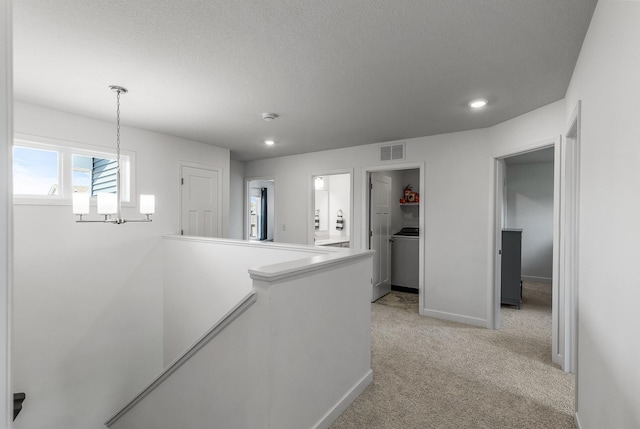 1959 Tamarack Rd, Carver, MN 55315 - hallway featuring an upstairs landing, a chandelier, light carpet, recessed lighting, and a textured ceiling