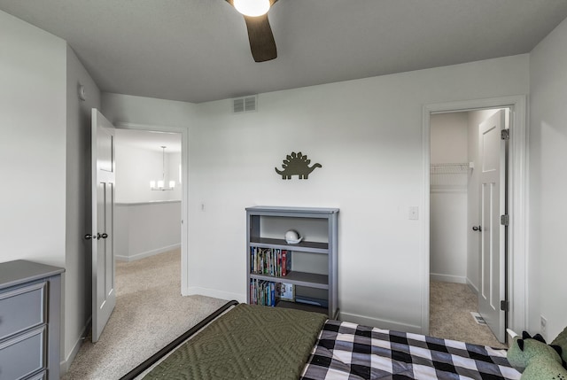 1959 Tamarack Rd, Carver, MN 55315 - bedroom with light carpet, a spacious closet, a chandelier, and ceiling fan