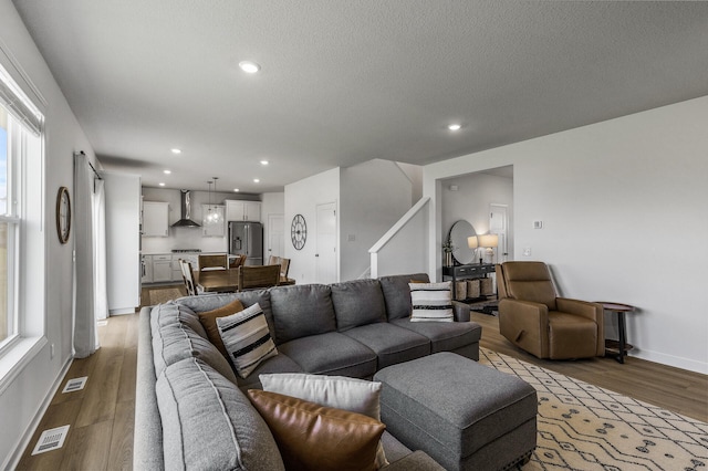 1959 Tamarack Rd, Carver, MN 55315 - living room with wood finished floors, stairs, recessed lighting, and a textured ceiling