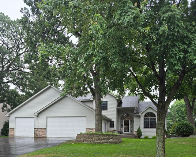 2248 151st Ave NW, Andover, MN 55304 - split level home featuring an attached garage, driveway, a front lawn, and stone siding