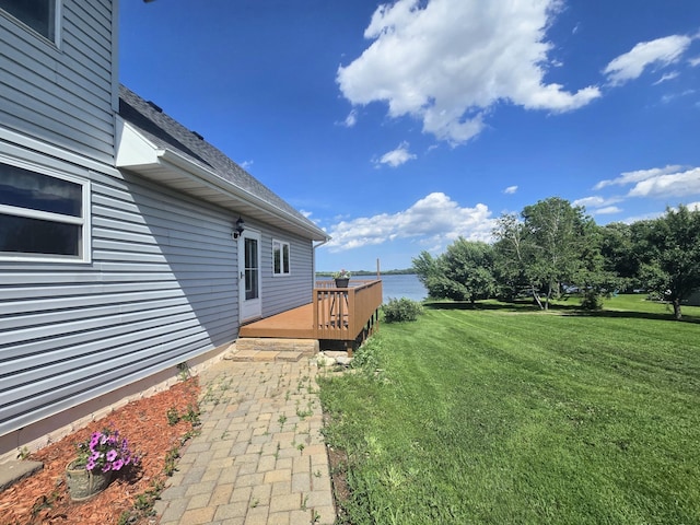 45356 140th St, Swan Lake Twp, MN 56235 - view of grassy yard with a deck with water view