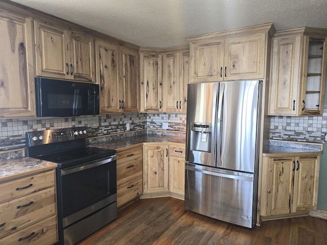 45356 140th St, Swan Lake Twp, MN 56235 - kitchen featuring stainless steel appliances, tasteful backsplash, dark countertops, a textured ceiling, and dark wood finished floors