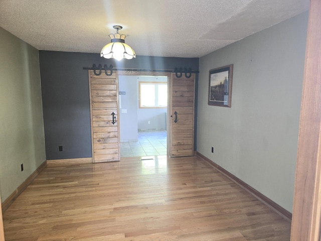 45356 140th St, Swan Lake Twp, MN 56235 - unfurnished dining area featuring a textured ceiling and light wood finished floors