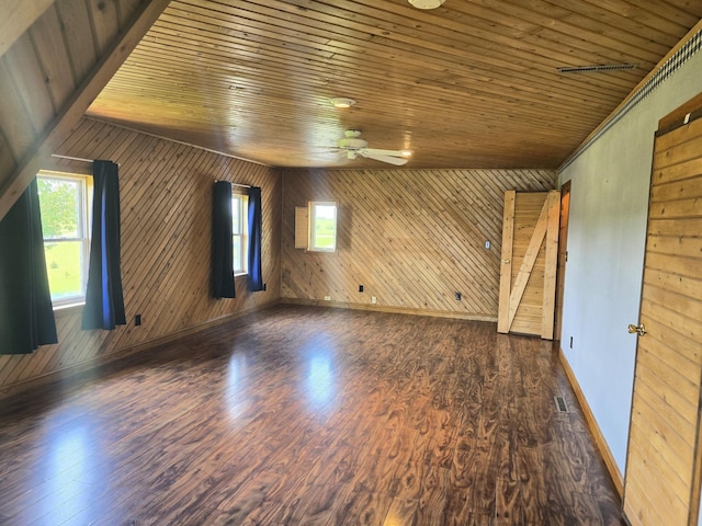45356 140th St, Swan Lake Twp, MN 56235 - empty room with a ceiling fan, wooden walls, wood ceiling, and dark wood finished floors