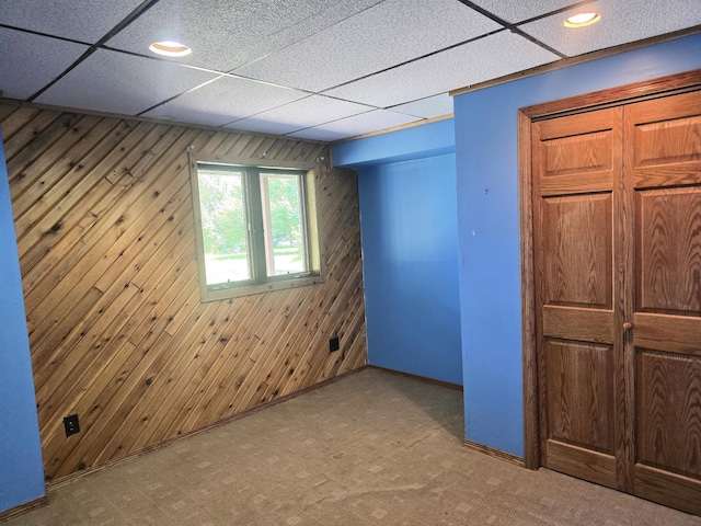 45356 140th St, Swan Lake Twp, MN 56235 - unfurnished bedroom with wooden walls, carpet flooring, and recessed lighting