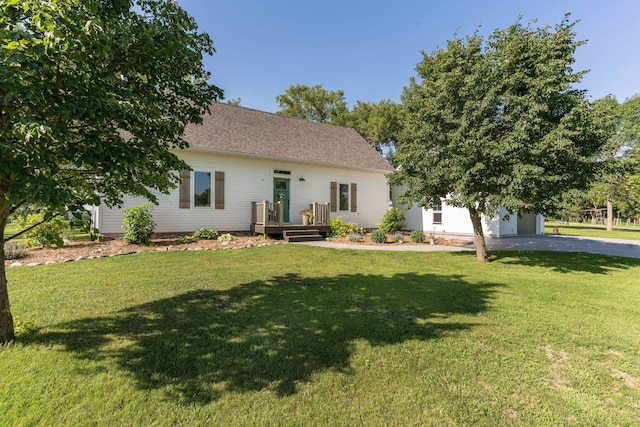 18377 County Highway 25, Fergus Falls, MN 56537 - view of front of house with driveway, a front lawn, a deck, an attached garage, and roof with shingles