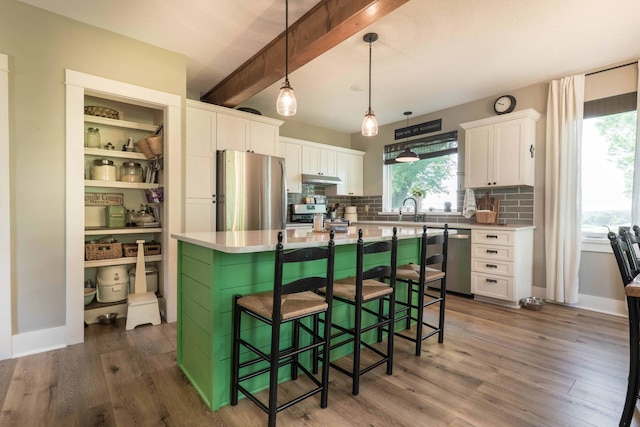 18377 County Highway 25, Fergus Falls, MN 56537 - kitchen featuring appliances with stainless steel finishes, white cabinets, beamed ceiling, decorative backsplash, and plenty of natural light