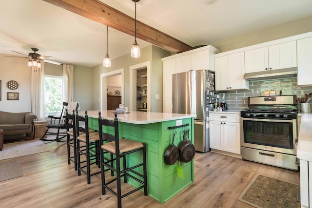 18377 County Highway 25, Fergus Falls, MN 56537 - kitchen featuring appliances with stainless steel finishes, under cabinet range hood, white cabinetry, decorative backsplash, and beamed ceiling