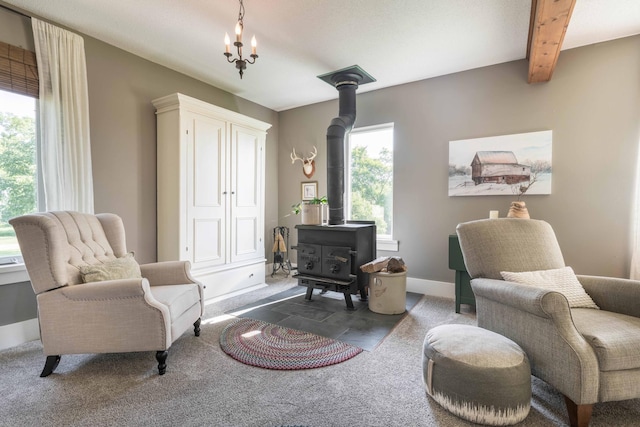 18377 County Highway 25, Fergus Falls, MN 56537 - living area with a wood stove, carpet flooring, beamed ceiling, and a chandelier