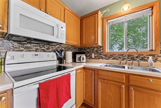 3902 Strathmore Ln SE, Rochester, MN 55904 - kitchen with white appliances, light countertops, decorative backsplash, brown cabinets, and a textured ceiling